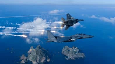 Zwei F-15K-Kampfflugzeuge der südkoreanischen Luftwaffe fliegen über die Insel Dokdo.