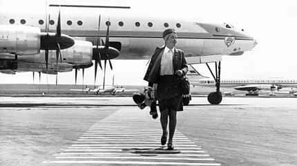 Tu-114 Stewardess inessa kirjavainen and her plane, the tu-114, at domodedevo airport, moscow, august 1968.