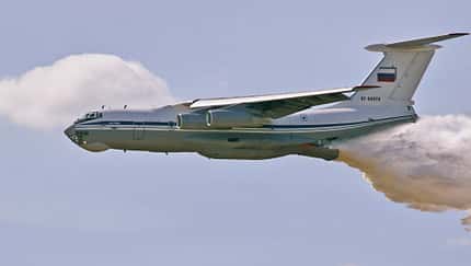 The Il-76 plane dumps water onto a tank range so that there