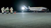 Bodenmannschaft in Schutzanzügen vor X-37B